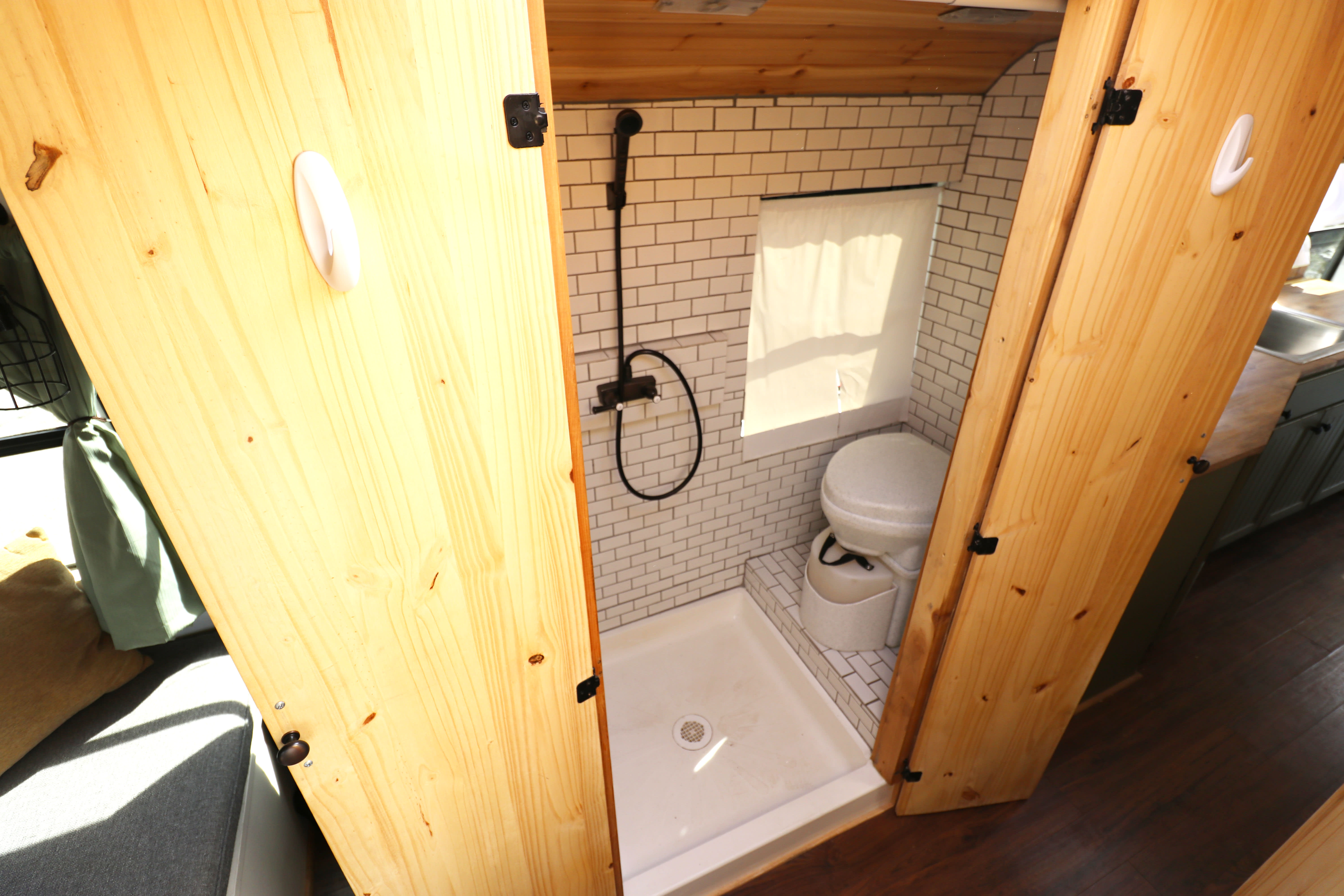 teeny tiny bathroom with shower toilet and sink